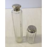2 silver topped glass bottles.