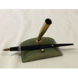 A Mont Blanc fountain pen in green onyx desk stand. c1950s, 14K gold nib. Repair to body of pen.