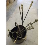 A quantity of brass fireside items, coal scuttle, fire dogs and companion set.