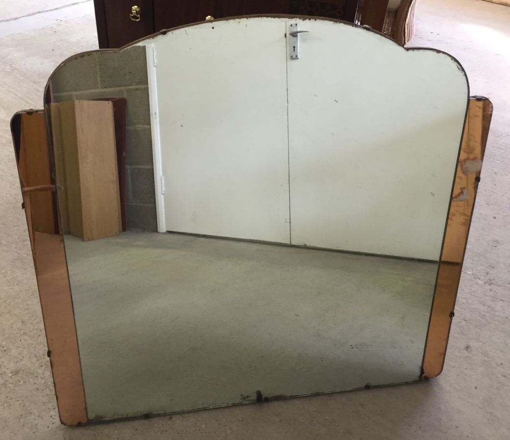 A c1930s mirror with orange glass edges.