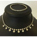 A vintage diamante evening necklace with white stones and matching bracelet.