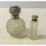 2 silver topped scent bottles, one Birmingham 1909 & the other hallmark worn.