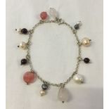 Silver bracelet decorated with rose quartz, cherry quartz, garnets and peach, white and grey