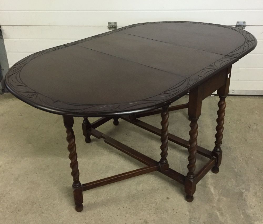 A drop leaf table with barley twist legs.