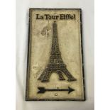 A cast iron reproduction Eiffel Tower sign.