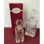 A boxed Royal Albert crystal decanter with another small decanter.