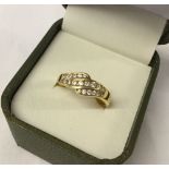 A gold plated silver ring with 3 rows of white stones. Size S.