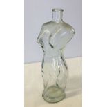 A glass 'naked lady' bottle.