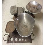 Two sets of cast iron weighing scales.