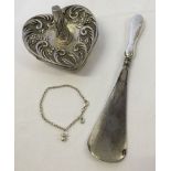 3 silver items: 1) a babies bracelet. 2) a ring stand and 3) a silver handled shoe horn.