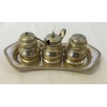 A silver plated condiment set with blue glass liners.