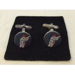 A pair of gents cufflinks with fabric 'Hunter with shotgun' decoration.