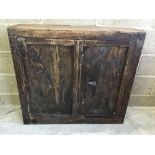 A vintage stained pine 2 door cupboard. 94cm wide and 85cm tall.
