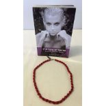 A boxed red coral & silver 18 inch necklace with a 'Lure of Gems' book.