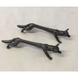 2 pewter knife rests in the shape of foxes (one with damaged leg).