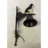 A cast iron reproduction standing black dog bell.