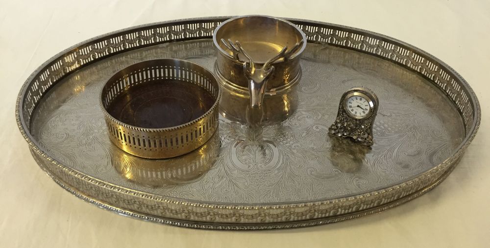 A small quantity of silver plated items to include a tray, coasters and a miniature clock.