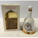 A boxed Bells whisky decanter sealed with contents (750ml) commemorating the Queens 60th birthday.