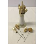 A collection of 10 vintage hatpins in a Noritake hat pin holder.