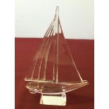 A glass yacht paperweight.