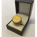 1911 full gold sovereign mounted in a heavy 9ct gold gents ring, size W. Total weight approx 18.4g.