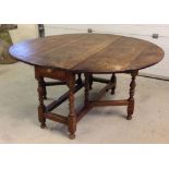 A large Georgian oak oval drop leaf kitchen table 133cm (4'4") 153cm (5') when open.