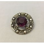 Scottish hallmarked silver brooch set with a large amethyst. Glasgow 1958. Approx 3cm in diameter.