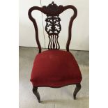 A Victorian mahogany lyre back nursing chair with red upholstered seat & china casters.