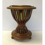 A Victorian mahogany wine cooler with brass liner and ball feet.