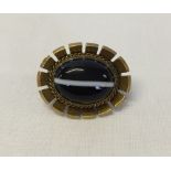 A Victorian pinchbeck brooch with banded agate stone 2.5cm long.