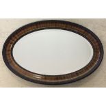 An early 20th century oval mirror.