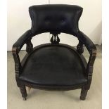 A Victorian black leather Captain's chair with dark stained wood