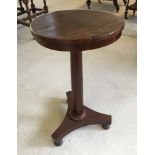 A Victorian mahogany tripod wine table.