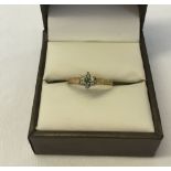 9ct gold dress ring set with central emerald stone surrounded by small diamonds. Size N½, weight