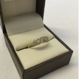 18ct gold ring set with 5 small diamonds in a platinum mount. Size N, weight approx 1.9g.