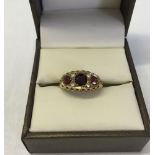 9ct gold ladies ring in a Victorian style set with 3 garnets and diamonds. Size L, weight approx 1.