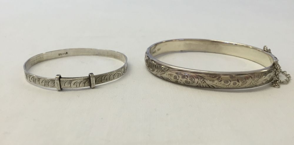 2 silver bangles, one a childs adjustable christening bangle and a hallmarked hinged bangle with