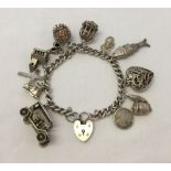 Hallmarked silver charm bracelet with padlock clasp and 12 charms. Approx weight 59g.