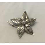 A 925 silver brooch in the form of a flower. Approx weight 6.7g, measures 4.5cm across.