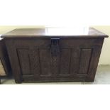 An antique oak coffer with carved decoration to front and ornate lock. Size 136 x 54 x 79cm tall.