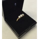 A 9ct gold trilogy ring set with 3 good size white stones. Size P, weight approx 1.4g.