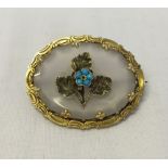 Vintage/antique crystal brooch, decorated with leaves and a flower set with turquoise beads. In a