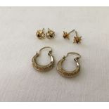 3 pairs of 9ct gold earrings, one star shaped set with small rubies, one a flower design set with