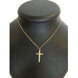 A 9ct gold cross on a base metal 16 inch chain.
