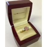 A pretty ladies dress ring with a pink and 2 white stones. Size N.