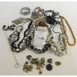 A quantity of costume jewellery to include a faux amber necklace.