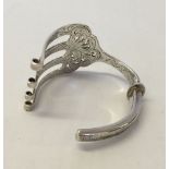 A HM Victorian silver bangle made from a fish serving fork. Sheffield 1851, approx 69.3g, maker A.