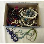 A box containing a large quantity of costume jewellery necklaces.