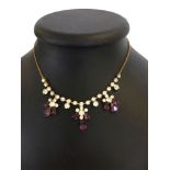 A costume jewellery necklace set with purple & white stones.