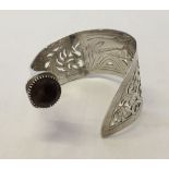 A HM Victorian silver bangle made from a fish serving knife with smokey quartz stone and pierced &